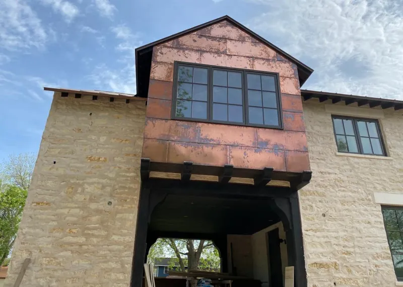 Copper metal panel facade on a stone building for Roof Repair in New Holland